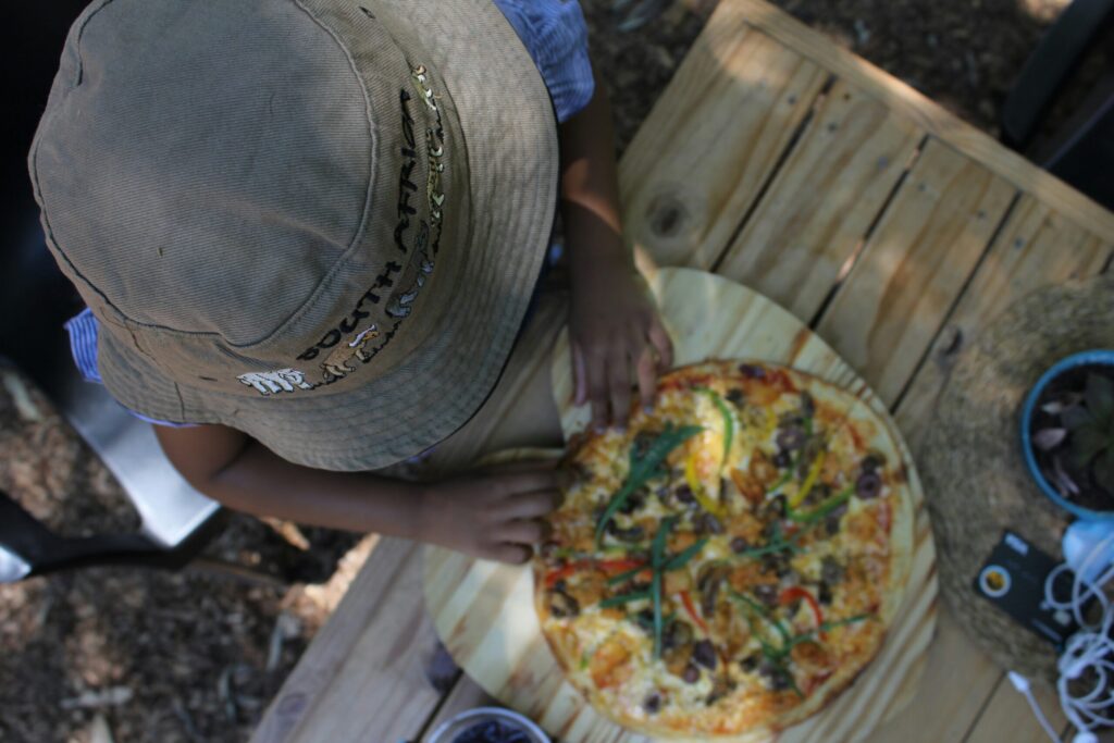 Overhead view of a child eating a pizza